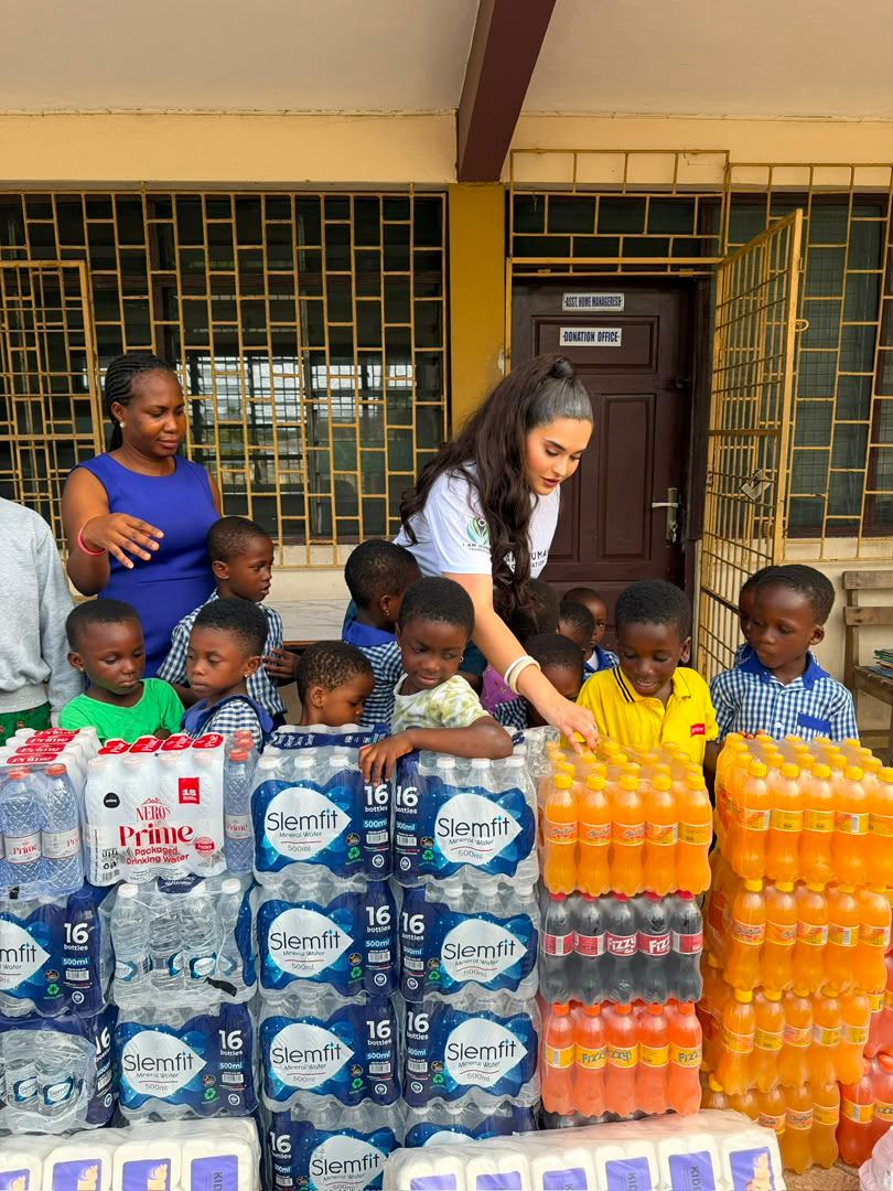 Schoolchildren gathered around pallets of donated drinking water and provisions