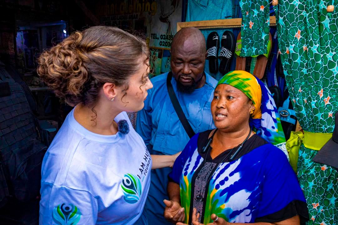 Shalimar Abbiusi in conversation with a trader and her husband at their market stall